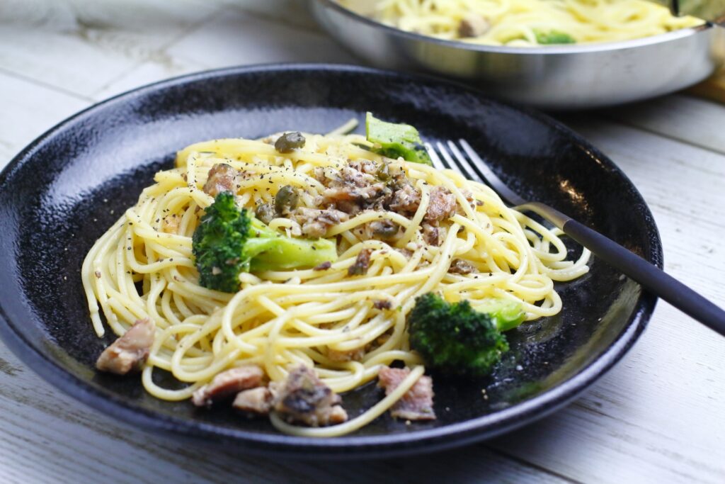 Savor the fusion of flavors: Japanese-style horse mackerel pasta, combining fresh fish, soy sauce, olive oil, and vibrant vegetables for a unique dining experience.